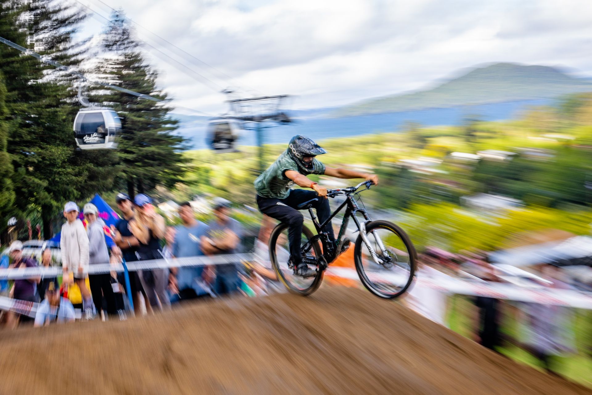 This photo was taken at the Crankworx Rotorua Mountain Biking Festival at an event called Speed N' Style.  The race is between 2 athletes on mountain bikes, mixing in tricks and flips, with speed and ability over various jumps and features.  I captured this image by performing a "zoom pull" with a slow shutter speed to create the effect that this athlete was travelling at 'warp speed.'